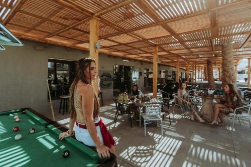 a woman standing in front of a pool table at Meraki Resort - Adults Only in Hurghada