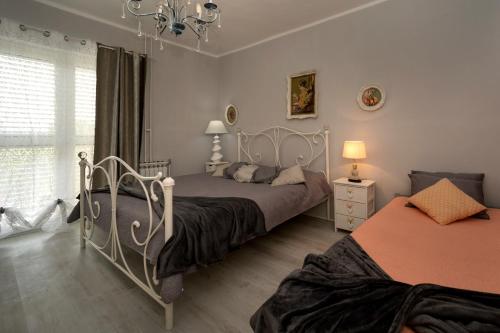 a bedroom with two beds and a window at Apartment Erceg in Poreč
