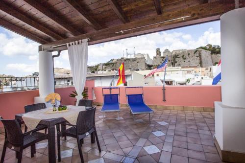 a patio with a table and chairs on a balcony at Residence Alberghiero Eolie in Lipari