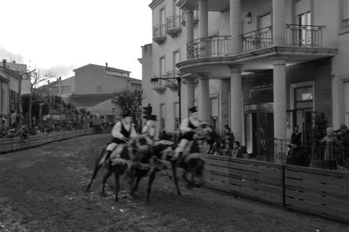 a group of people riding horses down a street at Mariano IV Palace Hotel in Oristano