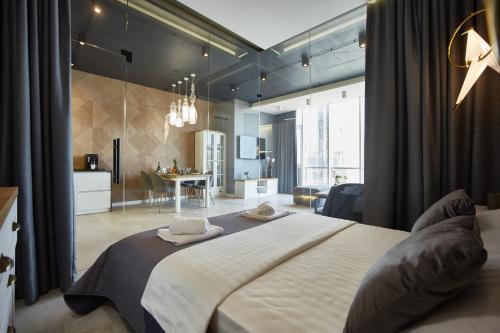 a bedroom with a large bed and a living room at Gagarin Plaza Luxury Sea View Apartments in Odesa