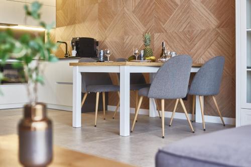 a dining room table with two chairs and a table at Gagarin Plaza Luxury Sea View Apartments in Odesa