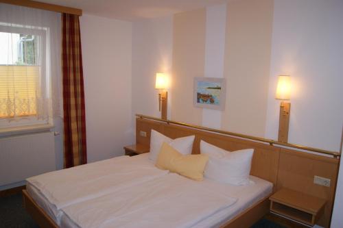 Voodi või voodid majutusasutuse Ferienwohnungen Ostsee & Mehr toas