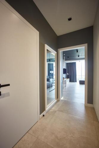an empty hallway with a door and a living room at Gagarin Plaza Luxury Sea View Apartments in Odesa