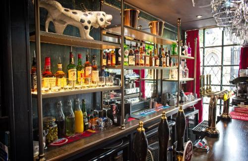a bar with a lot of bottles of alcohol at The Old Vicarage Hotel & Restaurant in Bridgwater