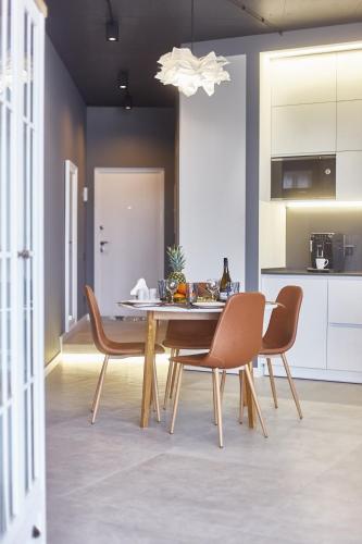 a dining room table and chairs in a kitchen at Gagarin Plaza Luxury Sea View Apartments in Odesa