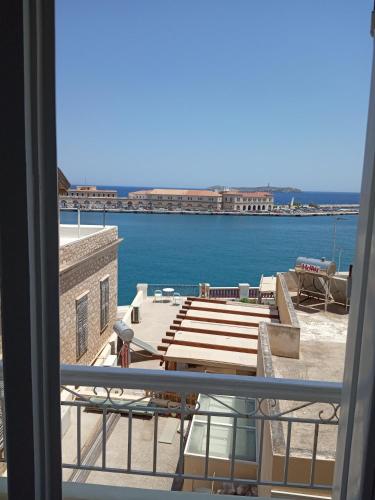 a view of the water from a balcony at ERRIKA in Ermoupoli