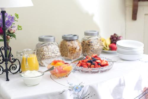 a table with jars of granola and a bowl of fruit at Church Farm B&B near Telford and Ironbridge in Shifnal