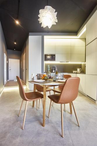a dining room with a table and chairs at Gagarin Plaza Luxury Sea View Apartments in Odesa