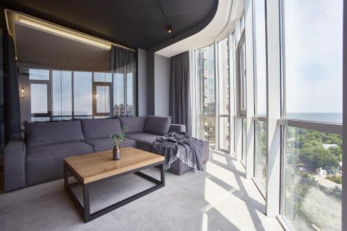 a living room with a couch and a table at Gagarin Plaza Luxury Sea View Apartments in Odesa