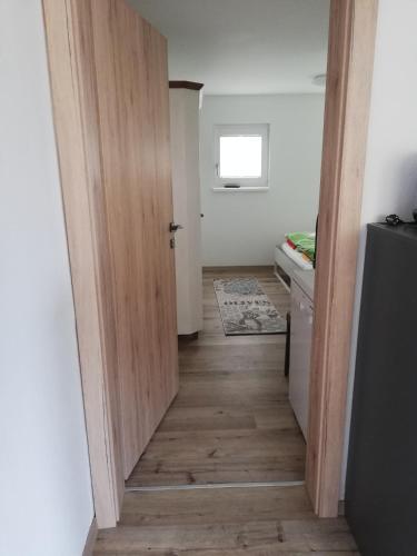 a hallway with a door leading to a kitchen at Ferienhaus Am-moore in Steindorf am Ossiacher See