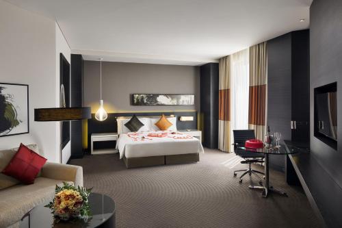 a hotel room with a bed and a couch at Fairmont Riyadh in Riyadh