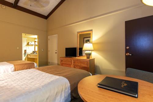 a hotel room with two beds and a table at Greenbo Lake State Resort Park in Argillite
