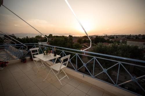 a balcony with a table and chairs on a balcony at Pistakion Houses in Aegina Town