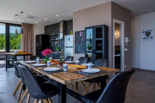 a kitchen and dining room with a wooden table and chairs at Villa The View Opatija in Opatija