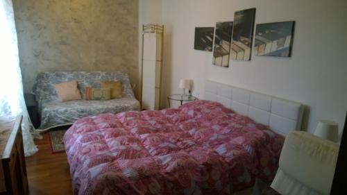 a bedroom with a bed and a chair at La Casa della Musica in Gorizia