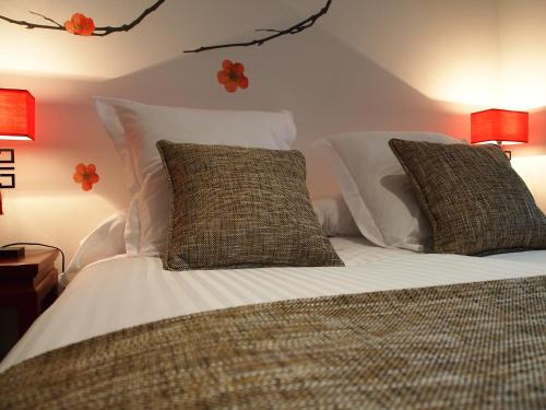 a bedroom with a bed with white sheets and pillows at Le Petit Boutique Hotel in Santander