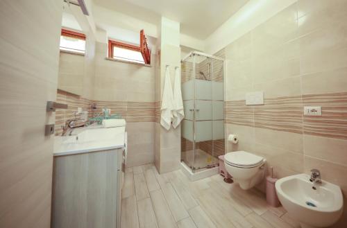 a bathroom with a sink and a toilet and a shower at Raimo House in Castellammare di Stabia