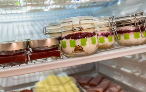 a refrigerator filled with jars of jam and desserts at Hostal Casa Mercedes in Nerja