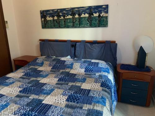 a bedroom with a bed with a blue and white quilt at Casa Marugi in Milan