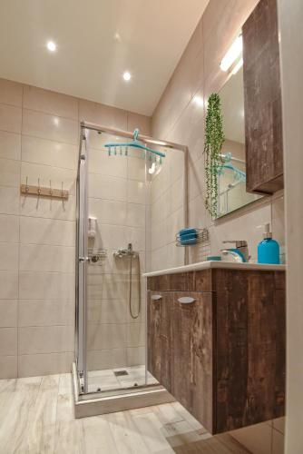 a bathroom with a shower and a sink at Blue Sea Y in Kavála