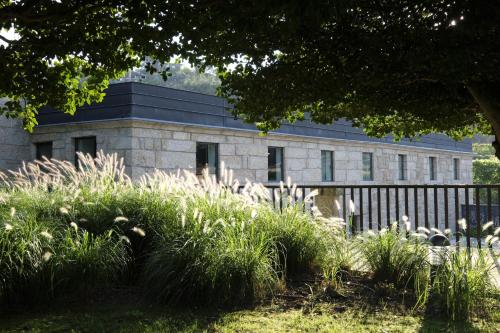 a stone building with a black roof at Quinta das Lavandeiras - Caldas de Vizela in Vizela