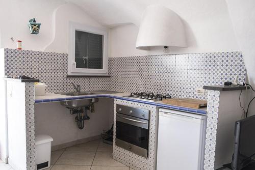 a kitchen with a sink and a stove top oven at Renato Canalone in Ponza