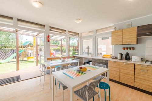 una cucina con un tavolo e sedie in una stanza di ZAKĄTEK ADELI a Mikoszewo