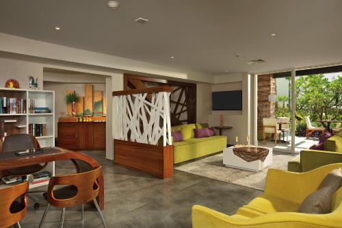 a living room with a couch and a table at Krystal Grand Los Cabos - All Inclusive in San José del Cabo