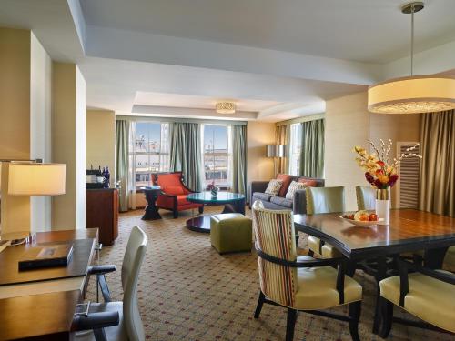 a living room with a dining table and a living room at Battery Wharf Hotel, Boston Waterfront in Boston
