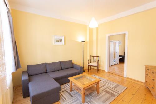 a living room with a couch and a table at Rodinný pension Bečov in Bečov nad Teplou