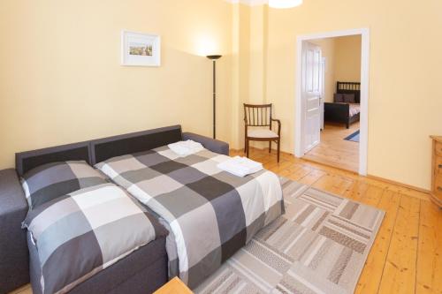 a bedroom with a bed and a living room at Rodinný pension Bečov in Bečov nad Teplou