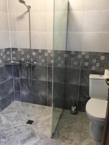 La salle de bains est pourvue d'une douche et de toilettes. dans l'établissement Cottages Ureki, à Ureki