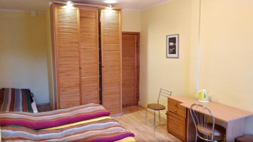 a bedroom with a bed and a wooden closet at Iwona Hostel - Budget Rooms with Private Bathrooms in Sopot
