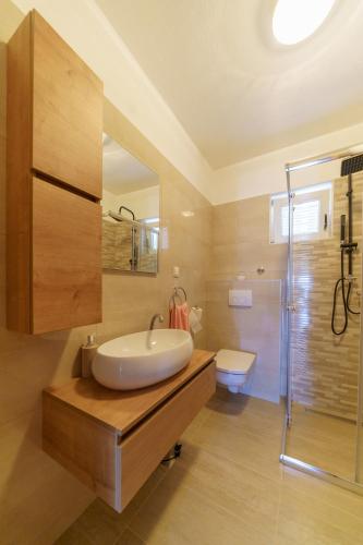 a bathroom with a tub and a sink and a shower at Holiday house Roko in Gornji Zemunik