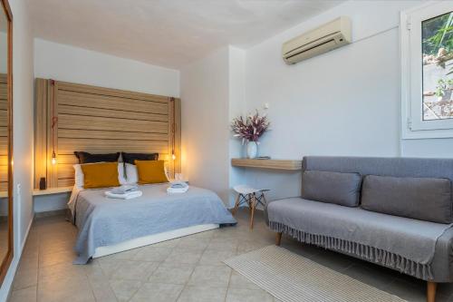 a bedroom with a bed and a couch at Coco Studio in Chania Town