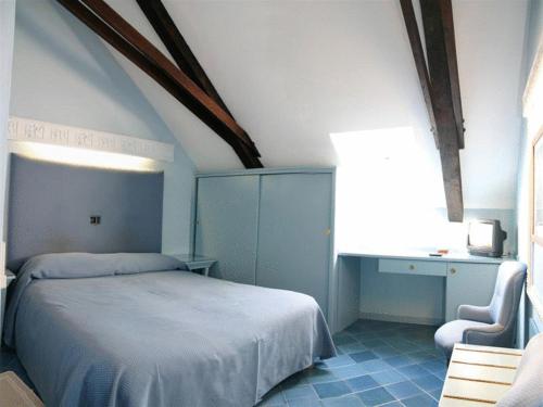 a bedroom with a bed and a desk and a chair at Hotel Villa Pina Antico Francischiello in Massa Lubrense