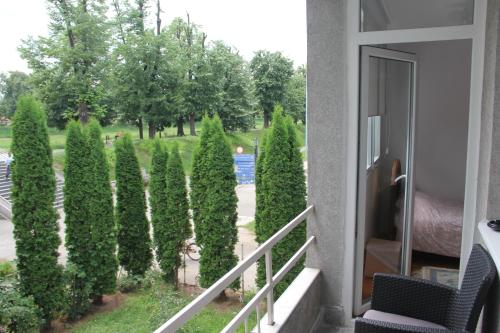 a balcony with a bunch of bushes and trees at Apartman KEJ in Pirot