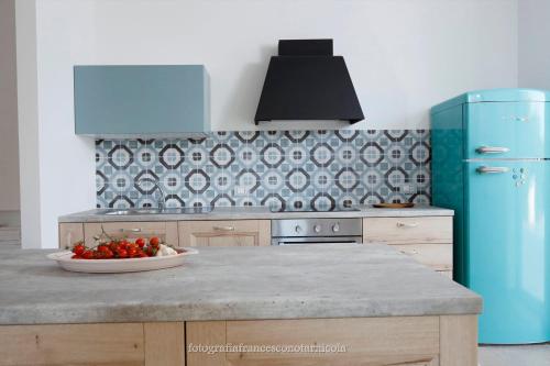 a kitchen with a bowl of fruit on a counter at Residenza Lippolis in Castellana Grotte