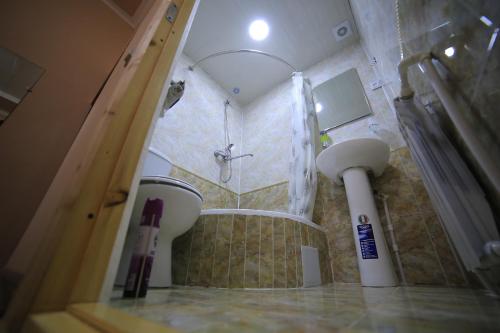 a bathroom with a shower and a sink at PARVIZ GUEST HOUSE in Bukhara