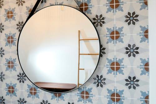 a mirror on a wall with blue and white tiles at Residenza Lippolis in Castellana Grotte