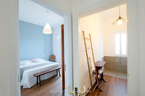 a bedroom with a bed and a ladder in it at Residenza Lippolis in Castellana Grotte