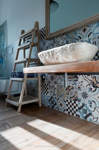 a bathroom with a counter with a sink and a ladder at Residenza Lippolis in Castellana Grotte
