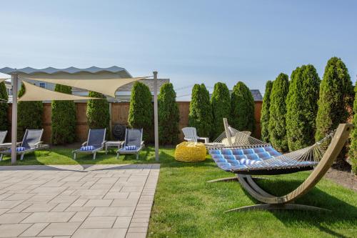 a yard with chairs and hammocks on the grass at The Ocean Resort Inn in Montauk