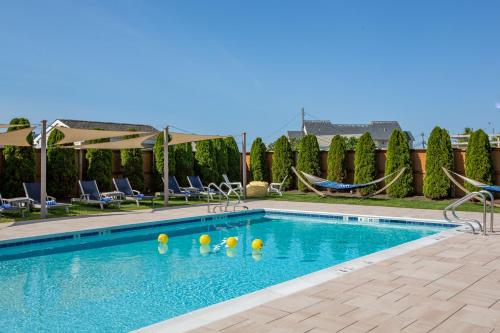 a swimming pool with volleyballs in the water at The Ocean Resort Inn in Montauk