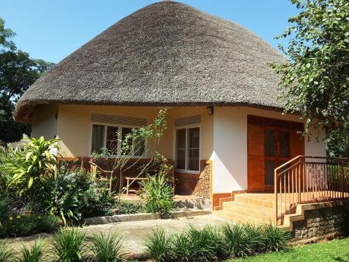 a small house with a thatched roof at Brownstone Country Home in Lira
