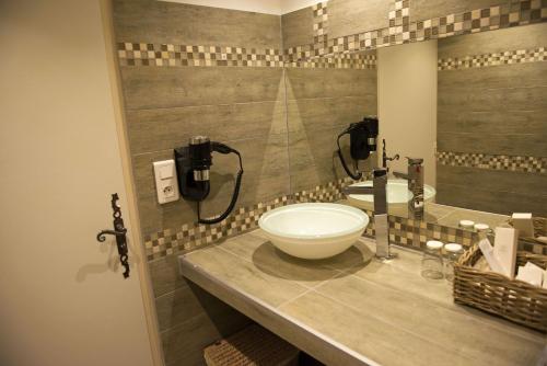a bathroom with a sink and a bowl on a counter at Altera Roma Hôtel in Avignon