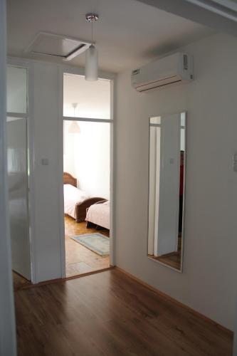 a bedroom with a mirror and a bed in a room at Apartman KEJ in Pirot