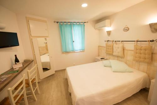 a hotel room with a bed and a mirror at Altera Roma Hôtel in Avignon