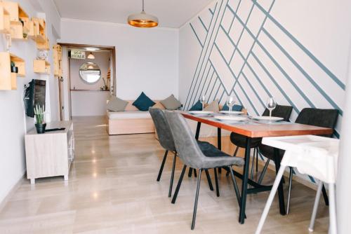 Toumpanakis Apartments في كياتو: غرفة طعام وغرفة معيشة مع طاولة وكراسي